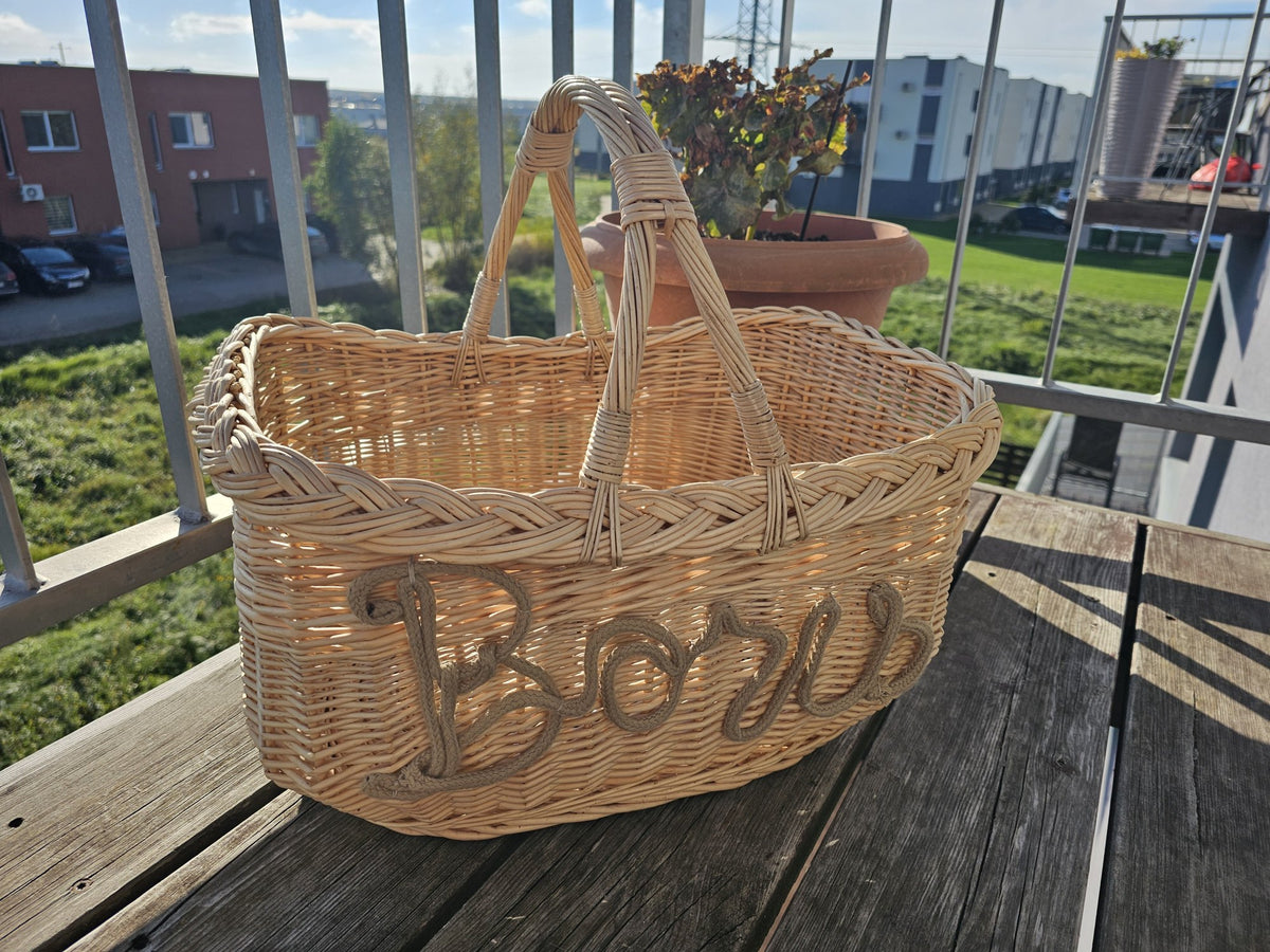 Willow basket with braided rim and rope name lettering on the side