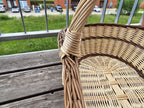 Close-up of the twisted handle joining the rim of the extra large willow trug, showing the woven oval base inside