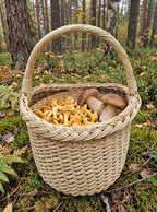 Handwoven willow mushroom foraging basket filled with chanterelles and porcini on the mossy floor of a pine forest