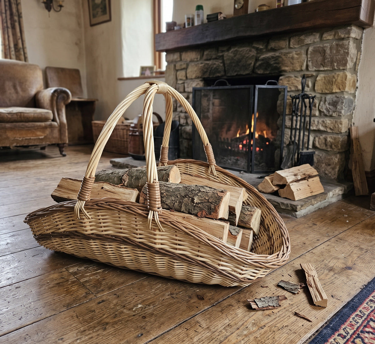 Large wicker garden trug with two tall handles holding split firewood logs on a wooden floor in front of a stone fireplace