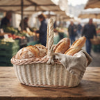 Wicker bread basket with arched handle holding crusty loaves and baguettes on a linen cloth at an outdoor market stall.