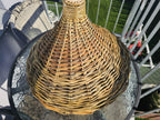 Willow bird feeder seen from above, showing the spiral weave of the cone roof