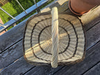 Top view of the large wicker harvest trug for flowers, showing the curved woven base and the tall twisted handle
