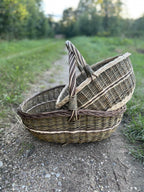 The small basket resting inside the large one on a gravel path