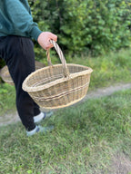 Small willow basket carried by hand, showing how light it is to lift