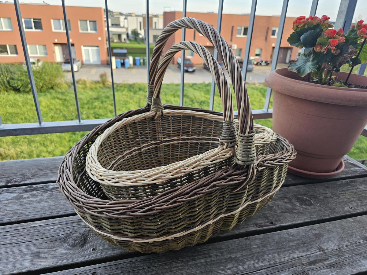 The smaller basket nested inside the larger one on a wooden bench