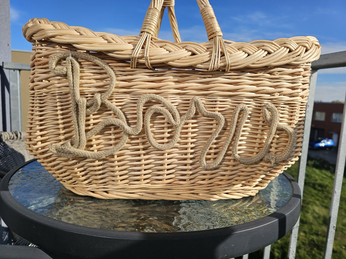 Close-up of rope lettering shaped by hand and fixed to the side of a willow basket