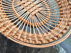 Close-up of the lattice centre, upright rods and plaited rim of an openwork willow tray