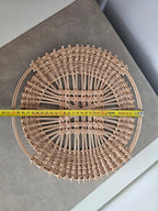 Openwork willow tray measured across with a tape measure, about 30 cm in diameter