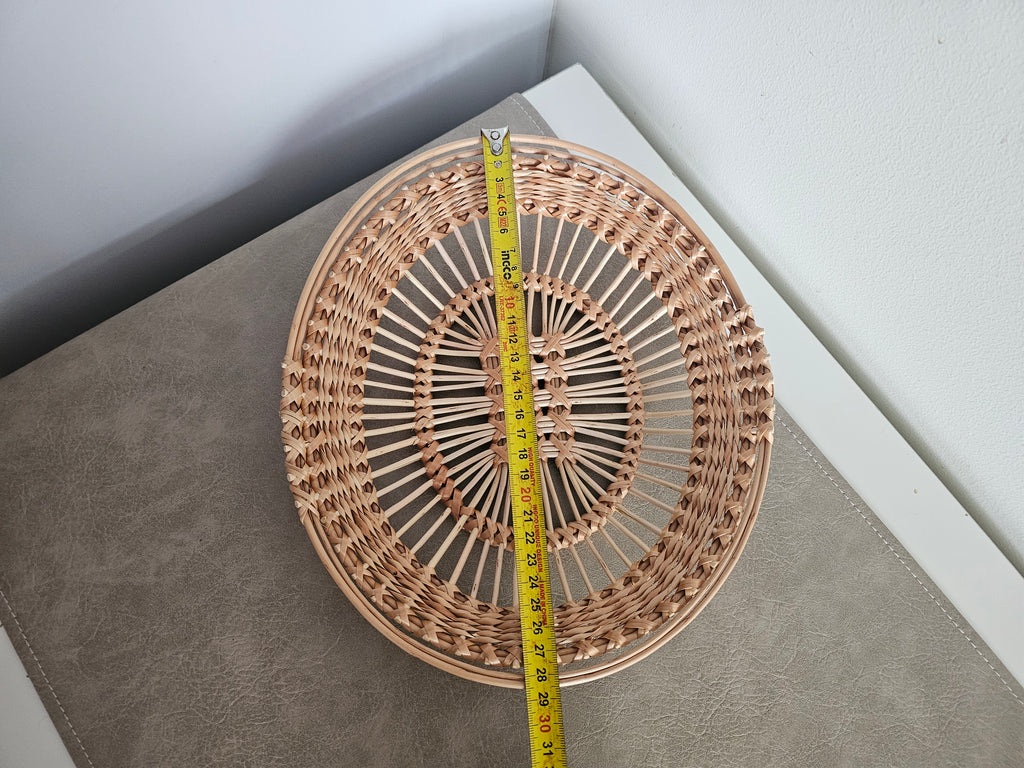 Oval openwork willow tray with a tape measure along its length