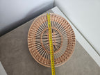Oval openwork willow tray with a tape measure along its length
