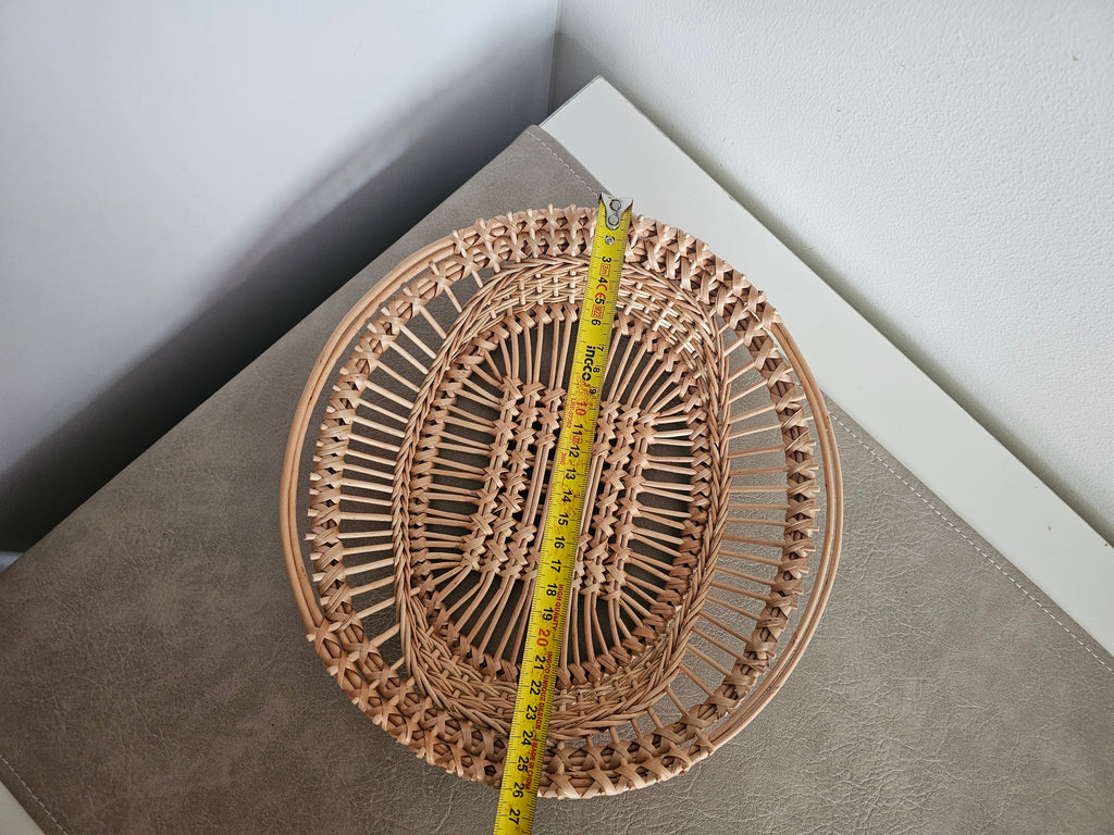 Oval openwork willow tray measured lengthways with a tape measure