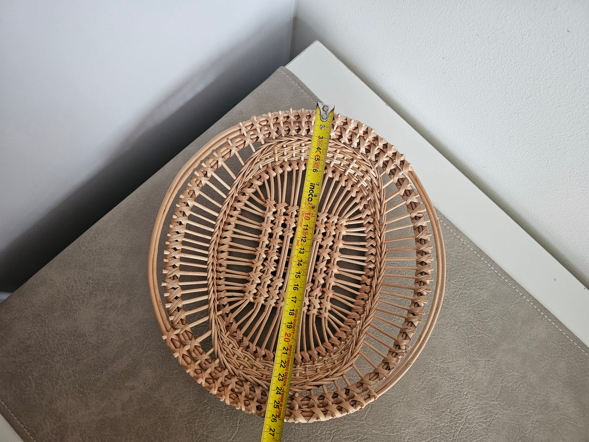 Oval openwork willow tray measured lengthways with a tape measure