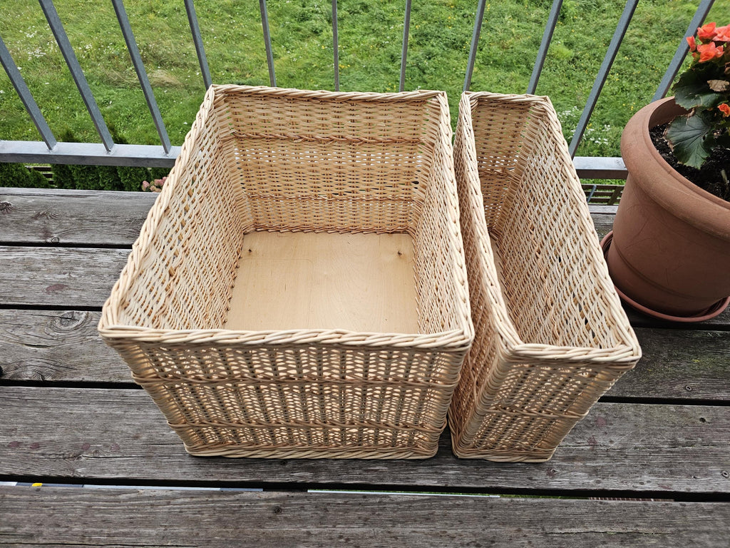 Both sizes of the rectangular willow storage basket side by side, showing the solid wooden board base inside