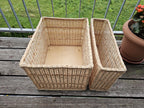 Both sizes of the rectangular willow storage basket side by side, showing the solid wooden board base inside