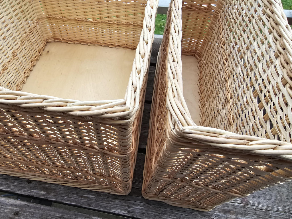 Close-up of the plaited rims and wooden board bases of the large and narrow willow storage baskets