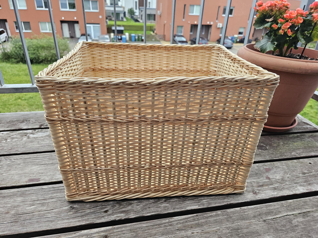 Front view of the large rectangular willow storage basket with straight sides and raised woven bands