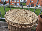 Close-up of the woven willow lid with its small arched handle and thick plaited rim