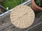 Top view of the round woven willow lid with arched handle