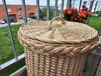 Close-up of the plaited rim and lid handle of the willow trash can