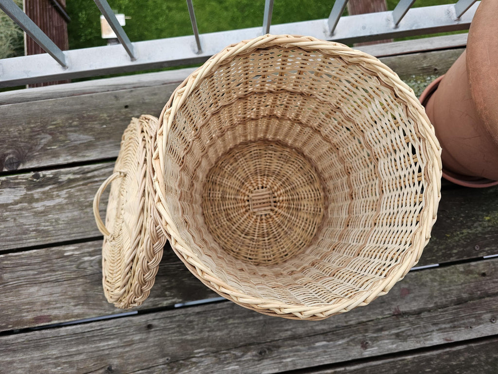 Willow bin lying on its side with the lid off, showing the woven inside and radial woven base