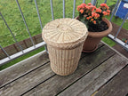 Willow bin with lid seen from above, the round lid sitting on the plaited rim