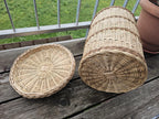 Woven willow lid and bin lying side by side, showing the radial woven base